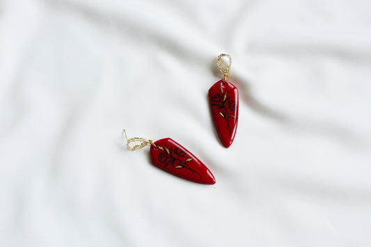 Red floral dagger statement earrings